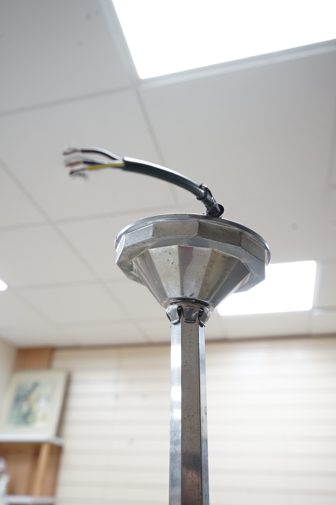 A French Art Deco chromed metal triple glass globed pendant ceiling light, 63cm high